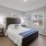 bedroom with bed wall art and large window