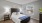 bedroom with bed wall art and large window