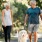 a man and a woman walking a dog on a leash